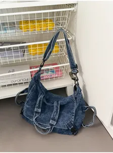 Detailed view of the retro washed denim shoulder bag, showing the texture and strap design.