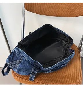 Vintage washed denim chest bag detail showing large capacity and black interior lining.