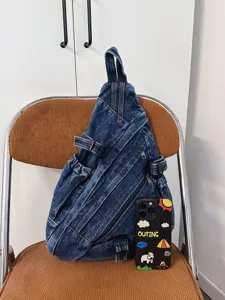 Vintage washed denim sling bag for women, casual crossbody chest bag with multi pockets.