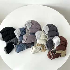 Detail view of warm winter trapper caps featuring soft plush ear flaps in vibrant assorted colors.