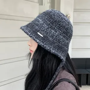 Detail view of dark grey knitted bucket hat with side ties, winter warm wool basin cap style.