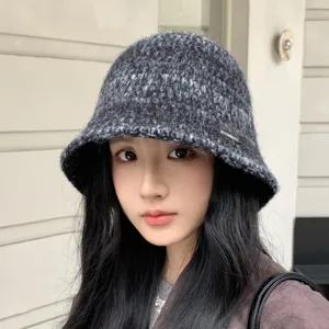 Dark grey knit bucket hat detail shot, cozy warm winter wool hat for women showing textured fabric.