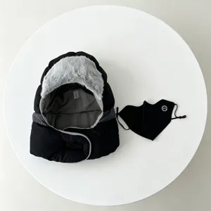 Detailed shot of winter warm ushanka hat with plush faux fur trim and matching black mask.