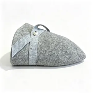 Grey wool felt hat detail, featuring a stylish silver ribbon and a delicate pearl button accent.