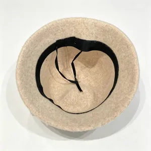 Interior detail view showing the adjustable black ribbon inside the warm wool hat lining.