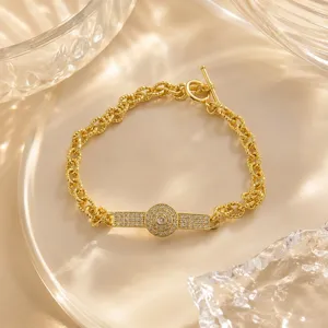 Exquisite gold-plated micro-paved zircon chain bracelet with chic center tag and T-bar clasp.