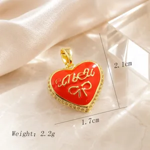 Gold plated red enamel heart pendant with bow design, elegant and charming jewelry piece.