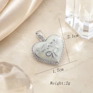 Copper gold-plated mother's love heart pendant with micro inlay rhinestones and bow detail.
