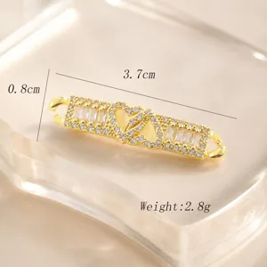 Close-up detail of gold double heart zircon DIY connector finding for handmade bracelets and chains.