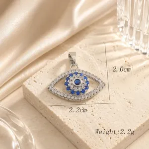 Close-up detail of exquisite evil eye pendant sparkling with blue and white cubic zirconia.