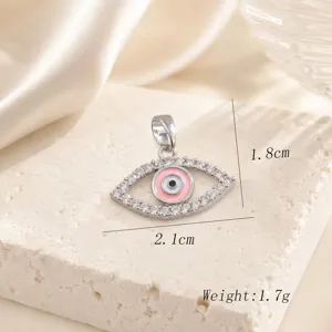 Exquisite evil eye pendant featuring sparkling zirconia and pink enamel in copper 18k gold.