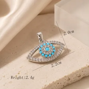 Evil eye pendant necklace charm with blue and white stones, elegant and stylish jewelry detail.