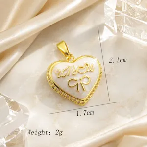 Gold-plated heart pendant with bow and cubic zirconia detail, elegant vintage jewelry.
