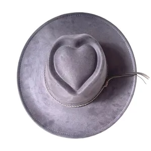 Close-up detail of grey faux suede western cowboy hat with unique heart crown design and tassel.