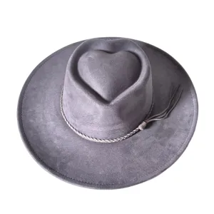 Grey suede western cowboy hat detail featuring unique heart crown and braided tassel band.