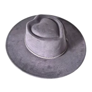 Close-up of dark grey suede western cowboy hat featuring unique heart crown and tassel band.