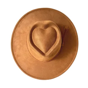 Close-up detail of brown suede western cowboy hat featuring unique heart-shaped crown design.