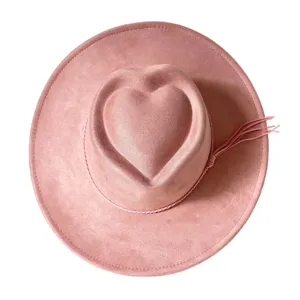 Close-up detail of the pink faux suede western cowboy hat featuring unique heart-shaped crown.