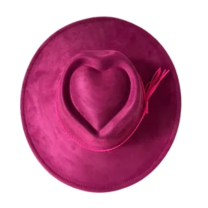 Retro pink suede wide brim cowboy hat with heart crown and tassel accent for party outdoor.