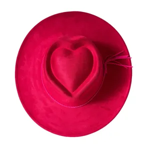 Wide brim pink suede western cowboy hat with heart crown and tassel detail for party outdoor.