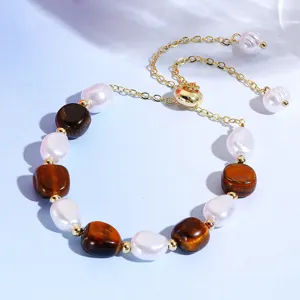 Detail closeup of natural stone and pearl beaded bracelet with elegant gold adjustable chain.