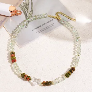 Chic beaded choker necklace featuring clear faceted crystals, green stones and heart pendant.