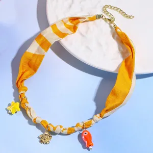 Yellow striped fabric scarf necklace with cute charms, stylish vacation choker for women.