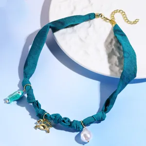Detailed view of the blue fabric scarf choker necklace featuring cute fish and pearl charms.