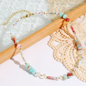 Exquisite vintage beaded necklace detail featuring colorful turquoise pearls and crystals on lace.