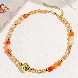 Retro orange beaded necklace with gold metal pendant, stylish clavicle chain for women.