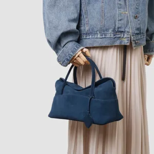 Vue détaillée du sac cabas en suédine bleu foncé, mettant en valeur sa texture et son style.