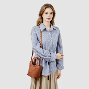 Elegant brown geometric crossbody bag featuring unique woven panel design and chic round handles.