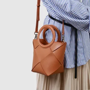 Elegant brown geometric woven leather crossbody bag with chic ring handles for women daily style.