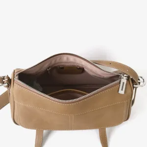 Détail intérieur de sac à main en cuir marron avec poche zippée et quincaillerie.