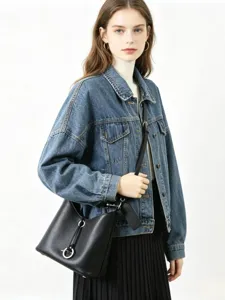 Élégant sac seau en cuir véritable noir doté d'anneaux en métal et d'une bandoulière tendance.