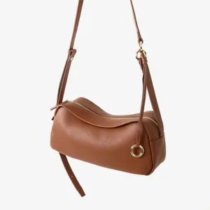 Gros plan du sac en cuir marron souple mettant en valeur sa texture douce et ses finitions métal.