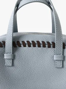 Sac à main Boston en cuir de vachette bleu clair avec détails tressés et deux poignées solides.