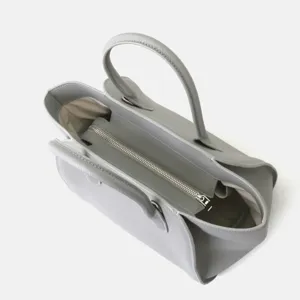 Sac cabas fourre-tout minimaliste en cuir gris avec design structure et fermeture zip securisee.