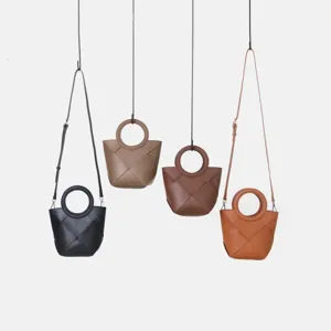 Detailed view of chic woven crossbody handbag featuring unique round handle and stylish design.