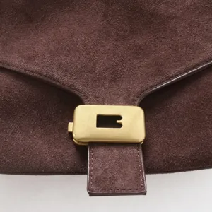 Sac de selle en cuir suédé marron avec détail de rabat à serrure en métal doré pour femme quotidien.