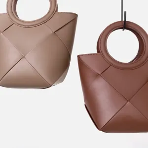 Elegant geometric woven leather handbag with circular handle, stylish casual daily carry bag.