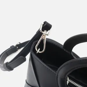 Black geometric crossbody handbag detail, premium leather tote bag with metal hardware.