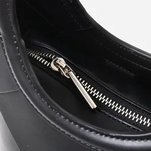 Detail view of the black handbag zipper and fine stitching, showing exquisite craftsmanship.
