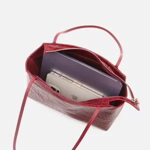 Detail view showing the spacious interior of the red crocodile pattern leather handbag.