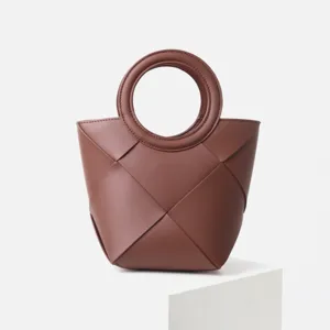 Elegant brown woven handbag with round handle, minimalist faux leather tote for women.