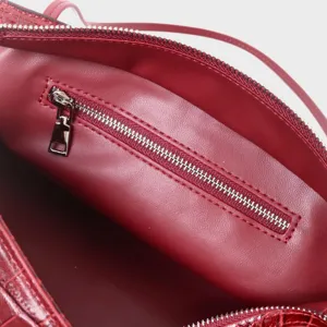Red crocodile embossed genuine leather handbag interior detail showing zipper pocket lining.