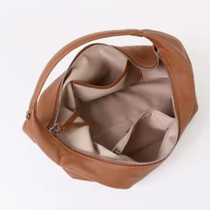 Vue détaillée de l'intérieur du sac hobo en cuir souple avec poches zippées et rangements.