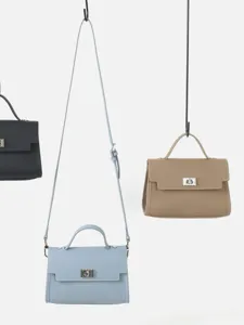 Sac à main minimaliste en cuir de vachette, bandoulière polyvalente et sacoche élégante.