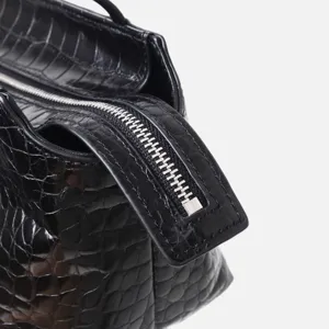 Black crocodile pattern top layer cowhide handbag detail, stylish commuting shoulder bag.