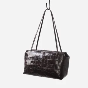 Detail shot of the crocodile embossed genuine leather underarm shoulder bag structure.